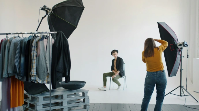 Photographer directing model in a studio photoshoot